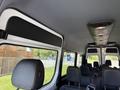 Interior view of a 2023 Mercedes-Benz Sprinter showing black seats and a ceiling with lights