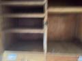A 2012 Workhorse W62 with a focus on its interior storage compartments showing wooden shelves and an empty space