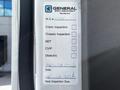A 2012 Freightliner M2 106 door with inspection stickers and labels including information for crane inspection chassis inspection and dielectric tests