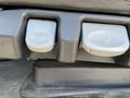 Two control buttons on the seat of a 2022 Freightliner Cascadia for adjusting seat position
