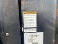 2008 Mitsubishi Fuso FE180 with warning label and capacity information for a Tommy Gate lift system
