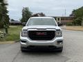 A 2016 GMC Sierra 1500 pickup truck facing forward with a chrome front grille and prominent GMC logo in red