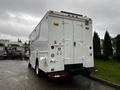 A white 2005 Workhorse W-Series vehicle with a boxy design featuring a rear entry door and utility compartments