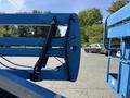 The image shows the front end of a 2012 Genie Z 45/25 aerial lift with its blue extended platform and hydraulic components visible