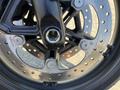 Close-up of a 2021 Harley-Davidson RA1250 S front brake rotor and caliper showcasing the disc and mounting bolts