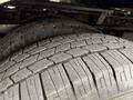 Close-up of the tread on two tires of a 2010 Ford Econoline showing the detailed patterns and texture of the rubber