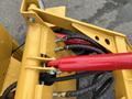 Close-up view of hydraulic hoses and fittings on a yellow AGT Industrial KRW23 Mini Loader
