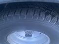 Close-up of a tire with visible tread patterns mounted on a wheel of a 2017 Chevrolet Express