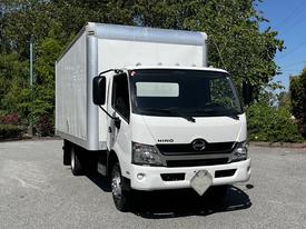 A white 2020 Hino 155 box truck facing forward with a silver cargo box and clear windows