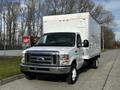 A white 2013 Ford Econoline box truck with a large cargo area and dual rear wheels parked on a pavement