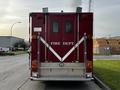 A red 1994 Freightliner FL80 fire truck with white markings and the words FIRE DEPT on the back