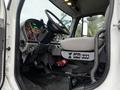 Interior view of a 2018 Freightliner M2 106 truck showing the driver's seat dashboard and steering wheel with various controls and gauges