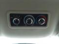 Control panel with three circular knobs for temperature and airflow settings in a 2011 Chevrolet Express