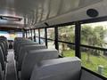 Interior view of a 2022 Freightliner B2 school bus showing rows of gray seats and large windows