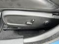 A black seat adjustment control panel for a 2022 Dodge Charger featuring a lever and a button