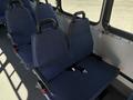 A row of blue fabric-covered seats with black armrests inside a 2017 Chevrolet Express van