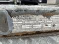 A close-up of a weathered identification tag on a 2011 Hightliner Aquacide Hot Water Weed Control Dual Flat Deck Trailer showing model specifications and manufacturing details
