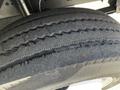 A close-up view of a worn tire from a 2009 Morgan Olson Workhorse showing visible tread pattern and signs of wear