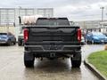 A 2022 GMC Sierra 3500HD pickup truck viewed from the rear showcasing its black exterior and distinctive taillights