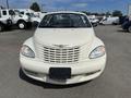 A 2005 Chrysler PT Cruiser is shown from the front with a distinctive grille and rounded headlights in a light color