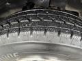 Close-up of a tire from a 2016 Chevrolet Express showcasing tread patterns and rubber details