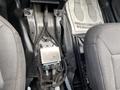 A 2021 Ford Explorer's interior view showing exposed wiring and a control module positioned between the front seats with fabric seat covers visible