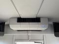 An overhead air conditioning unit installed in the interior of a 2021 Ford Econoline vehicle