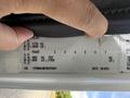 A hand pointing to the specifications label of a 2011 International 4300 truck showing vehicle identification number and weight details