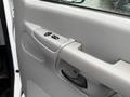 Inside view of the door of a 2006 Ford Econoline featuring a handle and electrical window controls