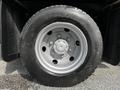 Close-up of a wheel from a 2015 Mitsubishi Fuso FE featuring a silver rim and black tire with visible tread pattern