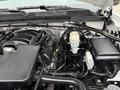 Engine compartment of a 2015 GMC Sierra 1500 featuring the engine, wiring, and various components including a coolant reservoir and battery compartment