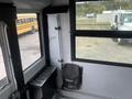Interior view of a 2007 Freightliner B2 showing the driver area with a monitor and cleaning equipment mounted on the wall