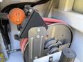 Close-up of a cable reel mounted inside a vehicle with red and black wires coiled around a metal drum and an orange connector attached