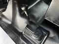 A black gear shift lever with a textured base in the cabin of a 2009 Ford F-550
