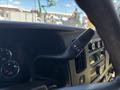 Close-up of the steering wheel controls in a 2020 Chevrolet Express showing buttons for adjusting settings and gauges