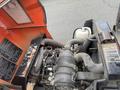Close-up of a 2015 Kubota F3990 engine with visible components including pipes and a black engine cover