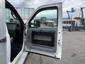 A 2015 Ford F-350 SD with an open driver's side door showing the interior door panel and handle