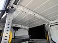 Interior view of a 2021 Ford Transit Connect showing the ceiling and metal shelving system designed for storage and utility purposes