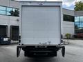 A white 2018 Isuzu NPR box truck viewed from the rear showing the back door and bumper