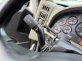 A close-up of the steering wheel inside a 2016 International 7600 showing the turn signal and wiper controls along with the dashboard gauges