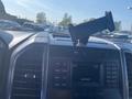 Interior dashboard of a 2017 Ford F-150 with a mounted smartphone holder and control panel displaying radio and media options