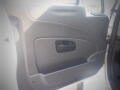 The interior door panel of a 2016 International WorkStar 7500 featuring a handle and storage compartment