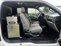 Interior view of a 2017 Ford F-150 showing gray cloth front seats and a metal toolbox mounted between them