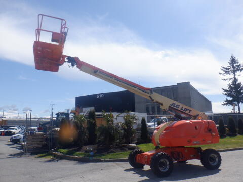 A 2008 JLG Boom Lift with an extended arm and a platform at the top, designed for reaching elevated work areas