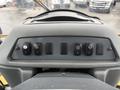 Dashboard controls of a 2011 John Deere 310SJ 4x4 Wheel Loader featuring several black switches for various functions