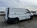 A damaged 2018 Mercedes-Benz Metris van with a white exterior and a dented side panel is parked in a lot among other vehicles