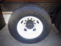 Close-up of a black tire mounted on a white rim with the Goodyear logo and markings on the sidewall showcasing a tread pattern designed for durability and performance