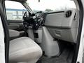 Interior view of a 2009 Ford Econoline showing the front seats and dashboard with a steering wheel and controls
