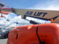 A 2008 JLG Boom Lift featuring a large orange base and an extended arm with the text JLG LIFT prominently displayed on the side