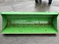 A green metal loader bucket designed for a 2003 John Deere 790 tractor with visible signs of wear and rust on its surface